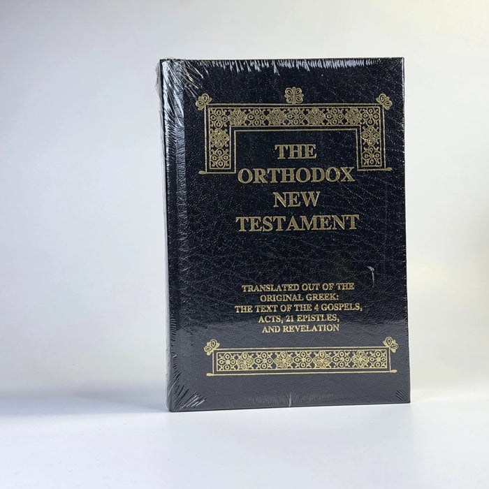 Black Orthodox New Testament book with gold text on a white background