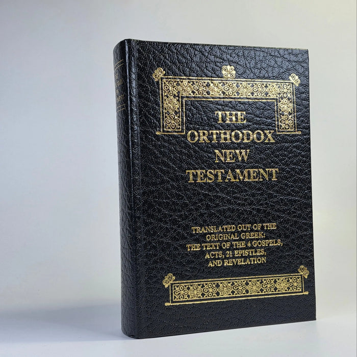 Black leather-bound book titled 'The Orthodox New Testament' on a white background