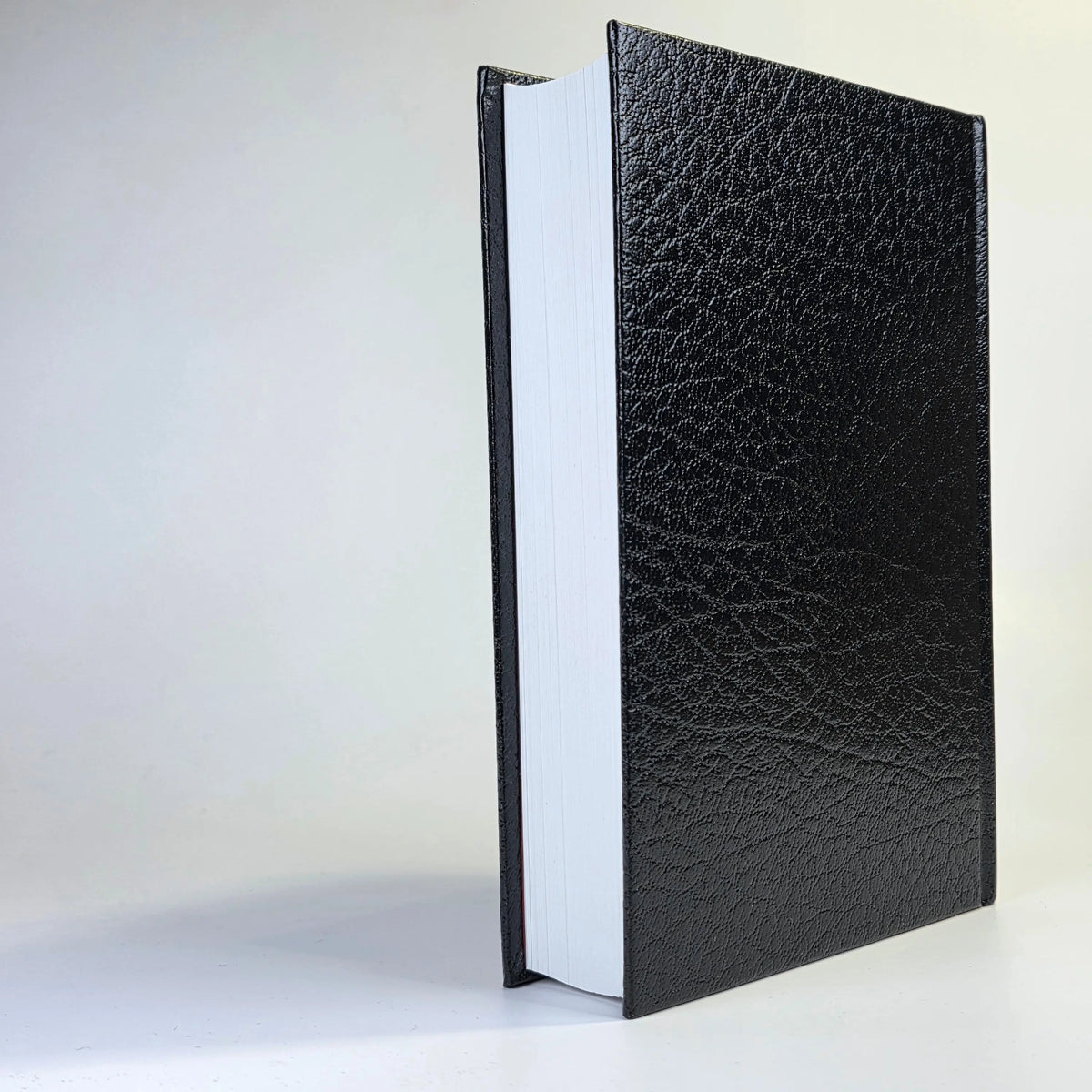 Black leather-bound book on a white background
