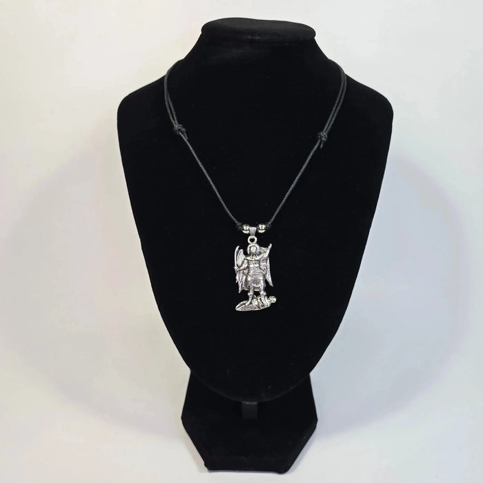 Necklace with a pendant on a black velvet stand against a white background