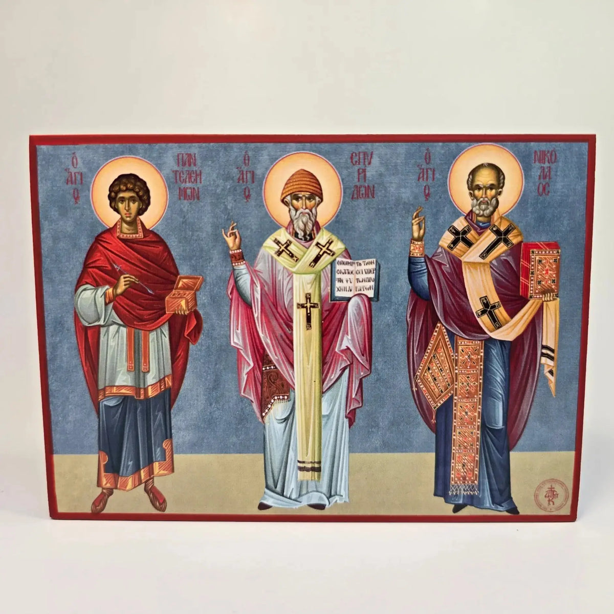 Orthodox saints icon featuring St. Panteleimon, St. Spyridon, and St. Nicholas in traditional iconography